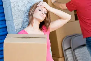 A woman getting stressed because her self-storage unit is too full.