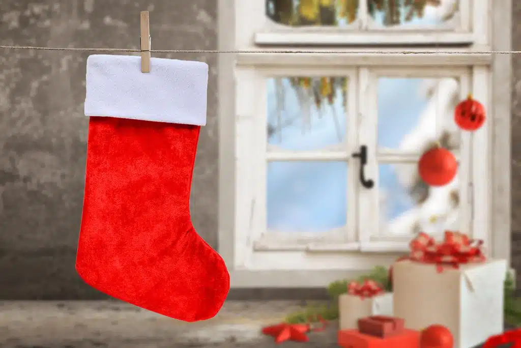 Empty Christmas stocking hanging on a cleaning line to dry with Christmas theme background